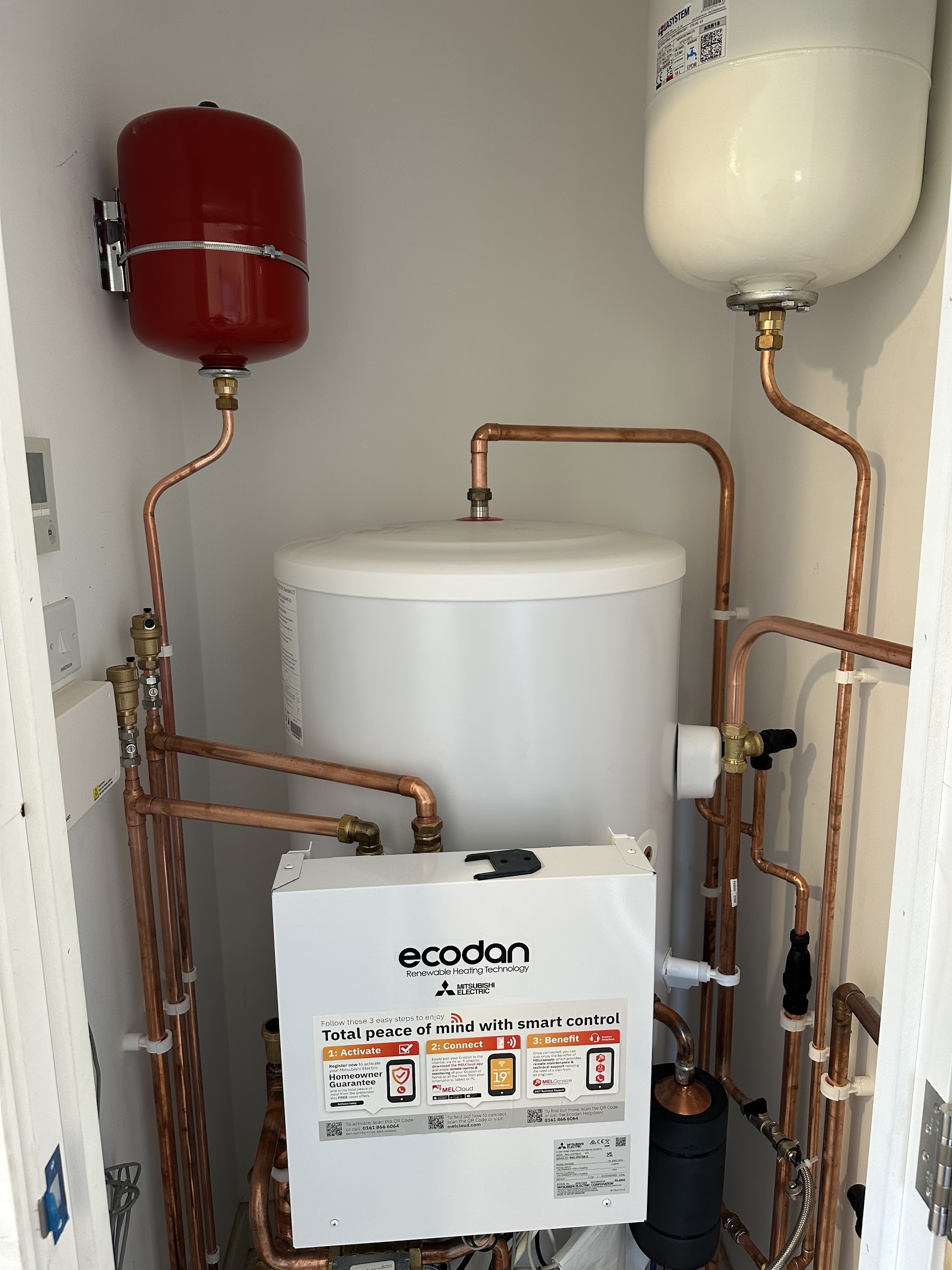Mitsubishi Ecodan hot water cylinder and controls installed in an airing cupboard