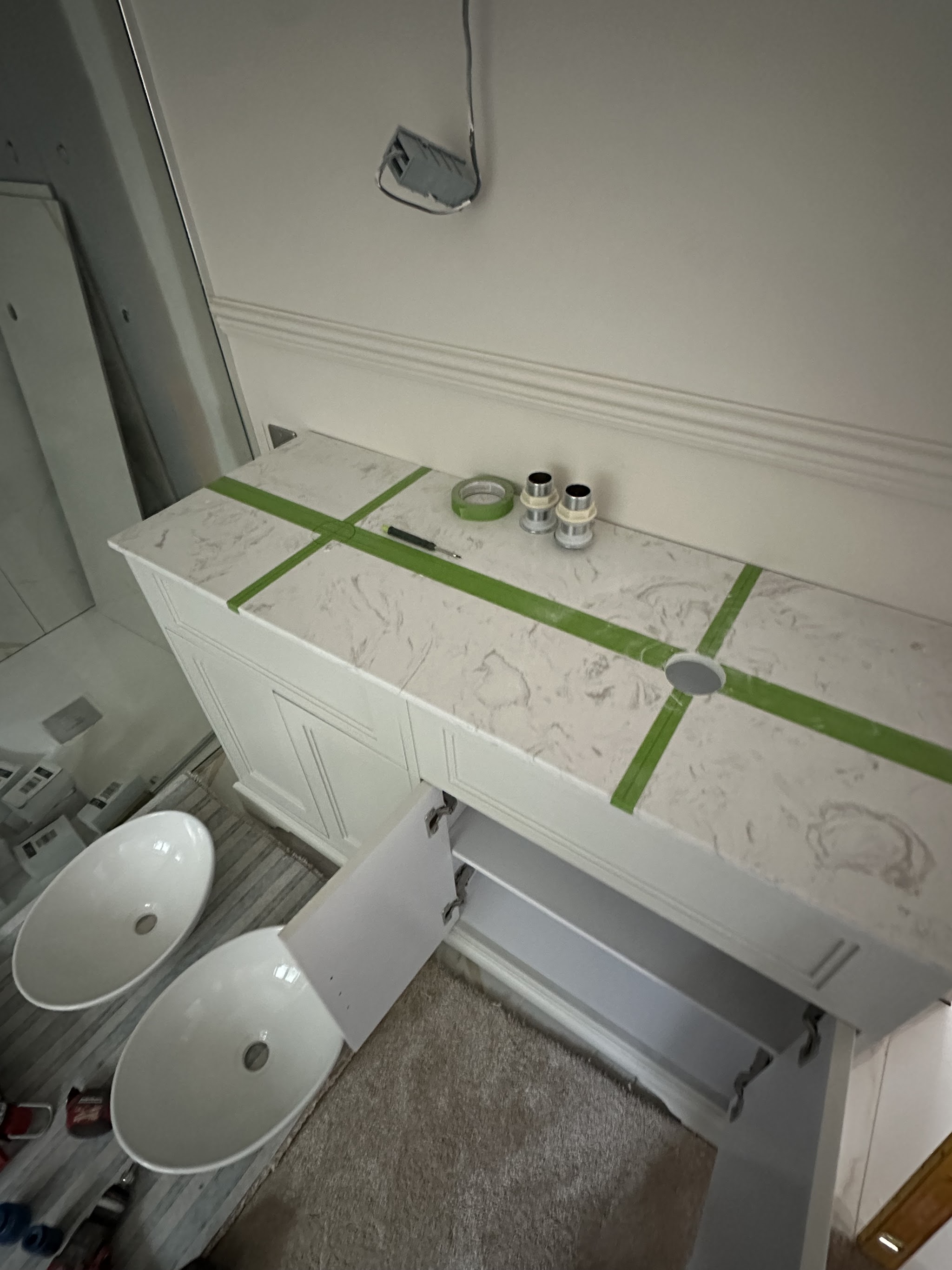 Twin-basin bathroom vanity being fitted