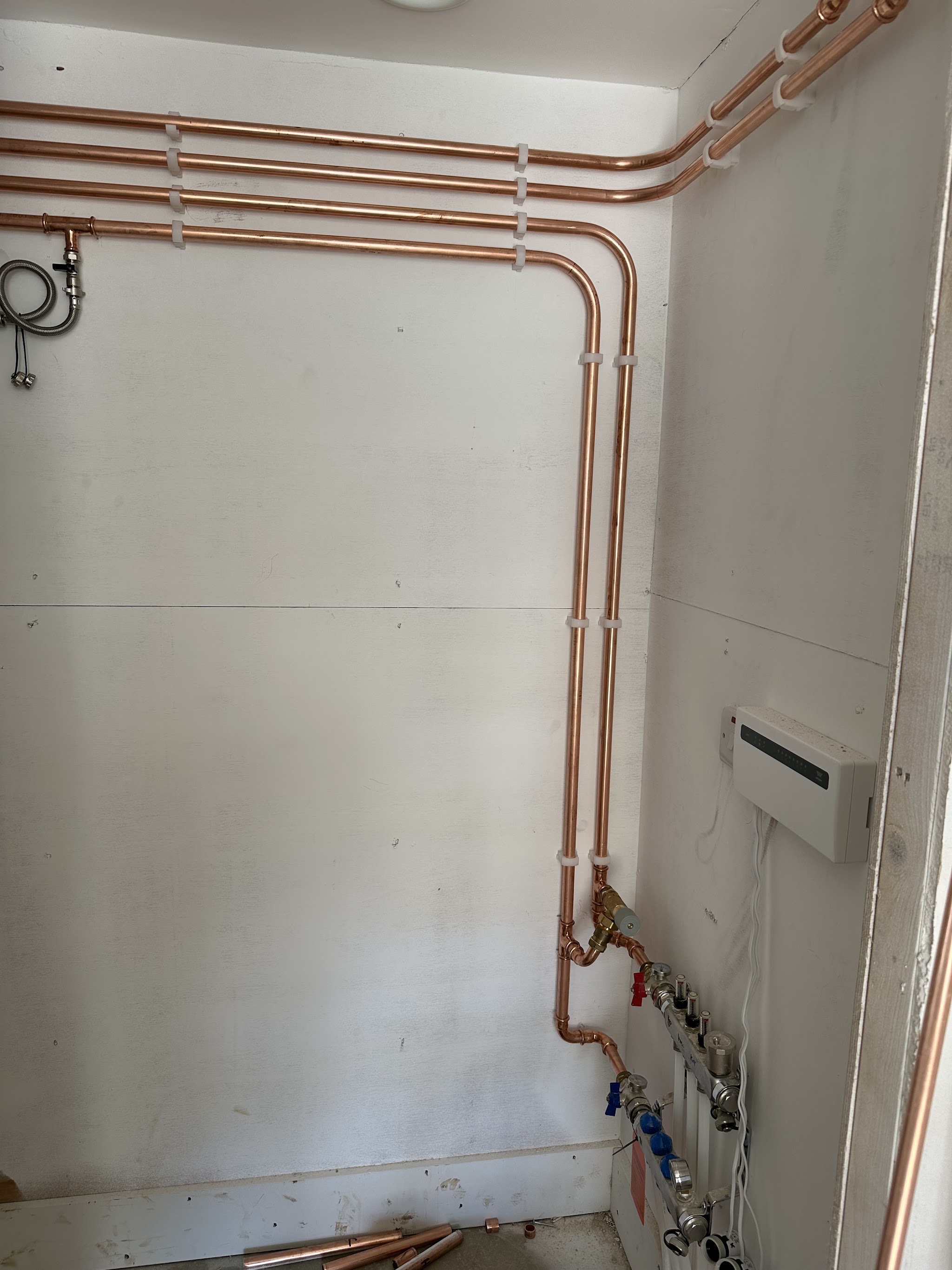 Neat copper pipe runs and valves installed in a plant cupboard